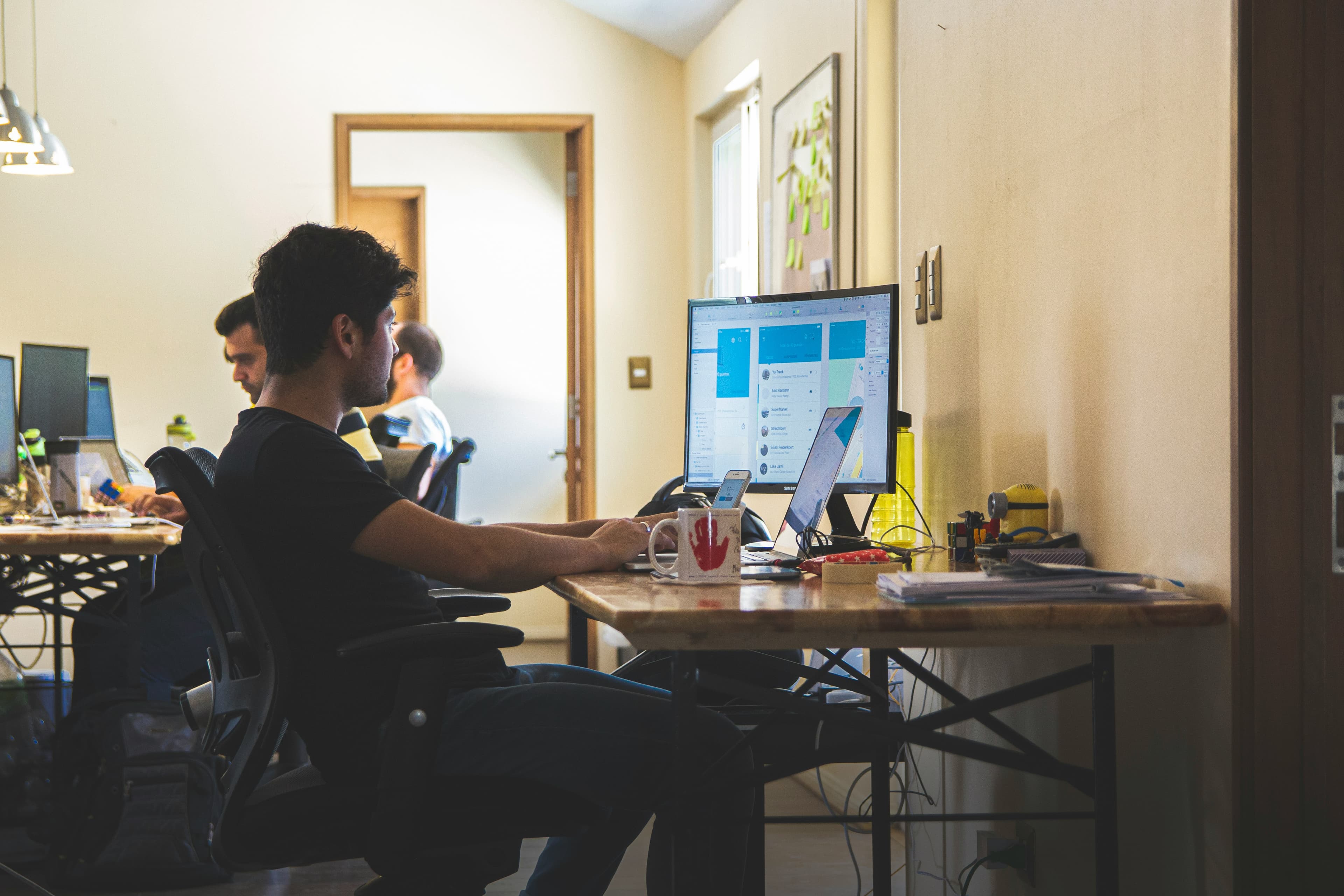 Operators discussing a business workflow at a shared workspace